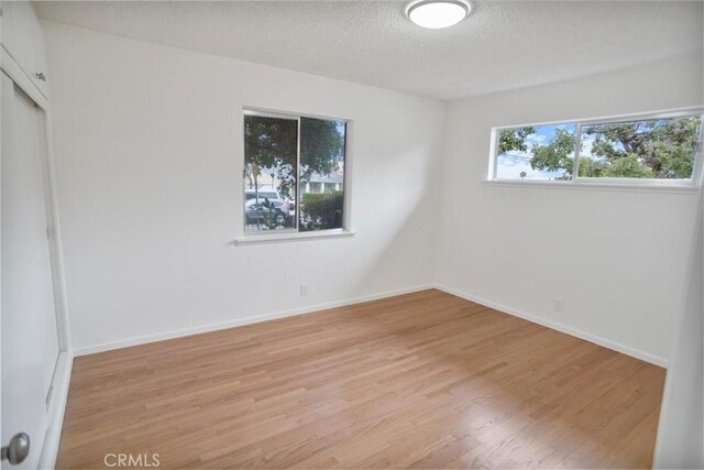 6833 Sultana Ave, San Gabriel, CA 91775 - unfurnished bedroom with light wood-style flooring, a textured ceiling, and a closet