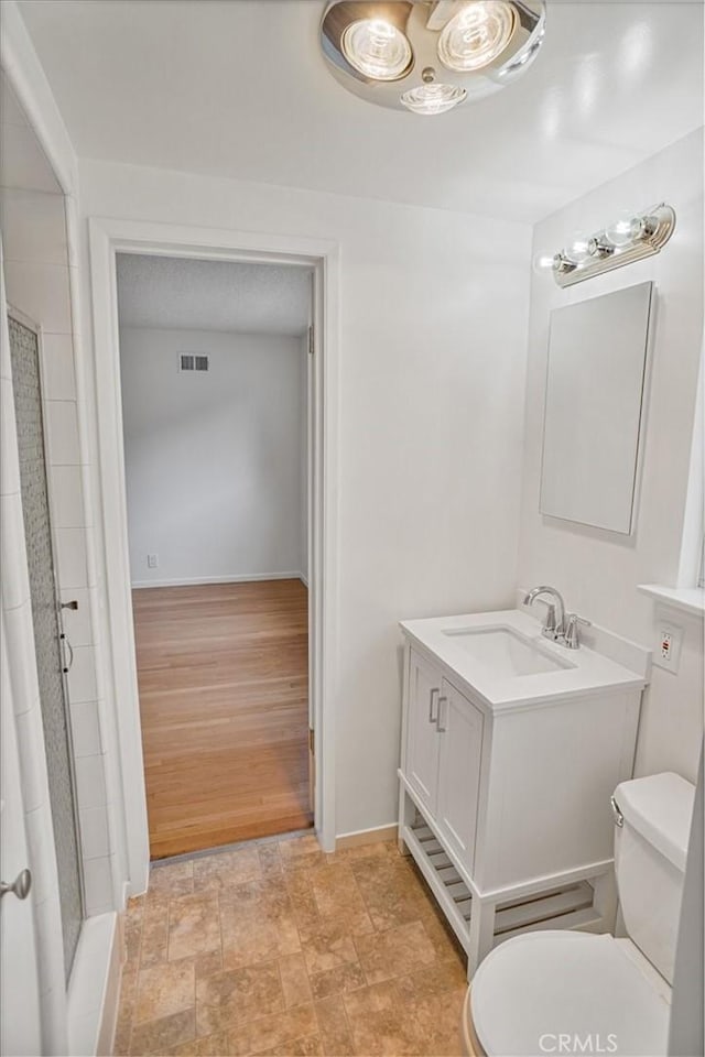 6833 Sultana Ave, San Gabriel, CA 91775 - bathroom featuring a shower stall, vanity, and stone finish floors