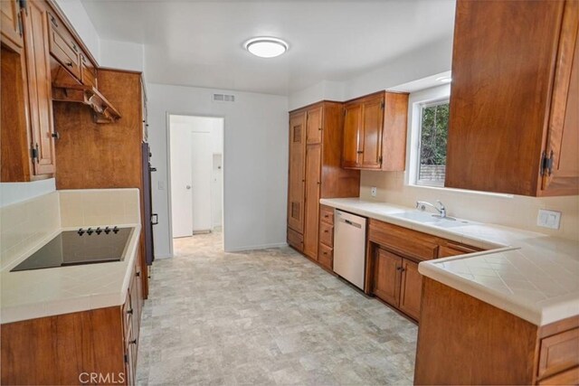 6833 Sultana Ave, San Gabriel, CA 91775 - kitchen featuring stainless steel dishwasher, black electric cooktop, brown cabinets, tile counters, and backsplash