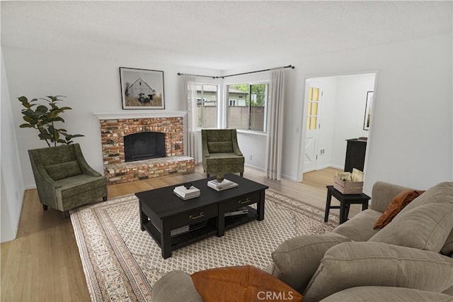6833 Sultana Ave, San Gabriel, CA 91775 - living room featuring light wood-type flooring and a brick fireplace