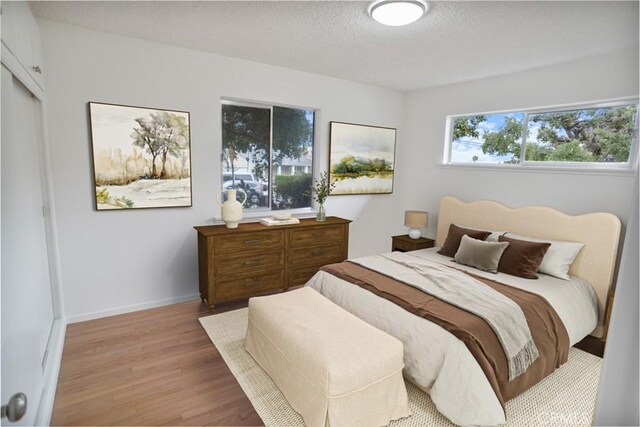 6833 Sultana Ave, San Gabriel, CA 91775 - bedroom with wood finished floors and a textured ceiling