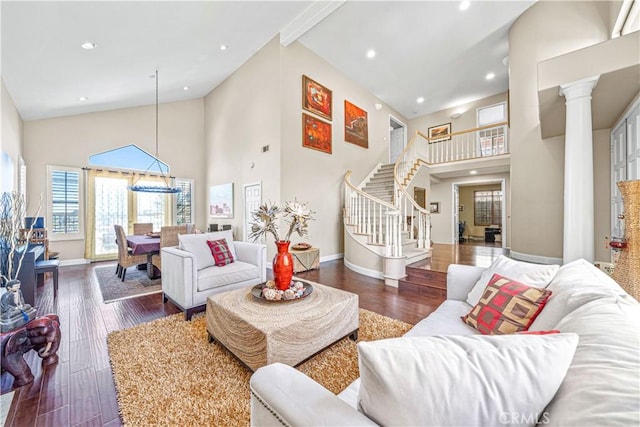 living room featuring wood finished floors, recessed lighting, high vaulted ceiling, and baseboards