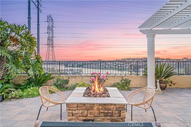 view of patio with an outdoor fire pit, fence, and a pergola