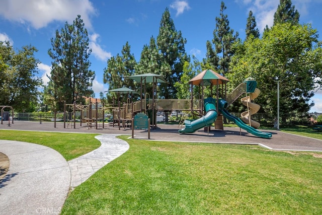 community jungle gym featuring a yard