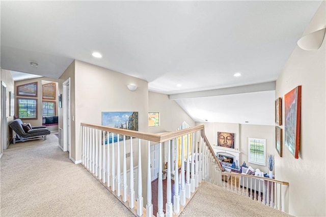 hallway featuring baseboards, recessed lighting, carpet floors, and an upstairs landing