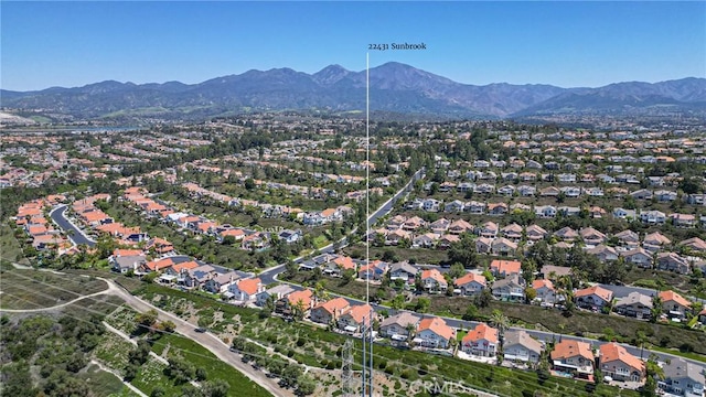 birds eye view of property with a mountain view and a residential view
