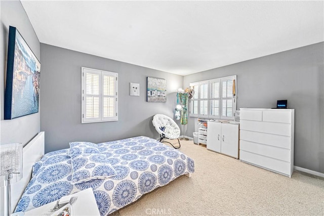 carpeted bedroom featuring baseboards