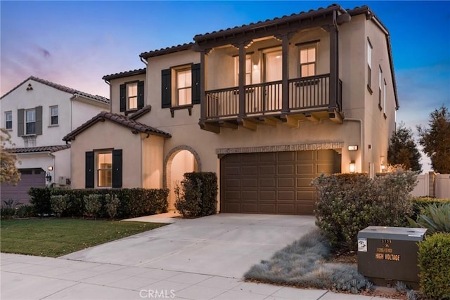 676 E Desert Willow Rd, Azusa, CA 91702 - mediterranean / spanish-style home with a front lawn, a balcony, stucco siding, driveway, and a garage