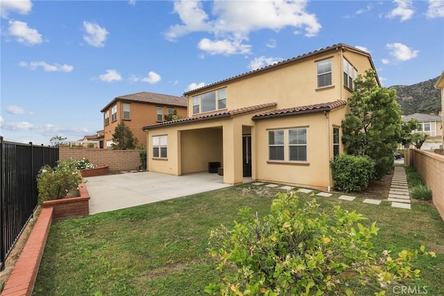 676 E Desert Willow Rd, Azusa, CA 91702 - back of property featuring a lawn, a tiled roof, a fenced backyard, a patio, and stucco siding