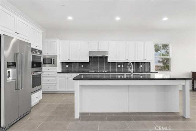 676 E Desert Willow Rd, Azusa, CA 91702 - kitchen featuring backsplash, appliances with stainless steel finishes, under cabinet range hood, and white cabinets