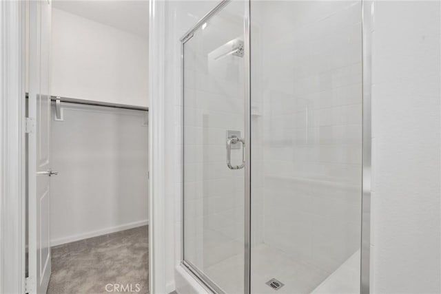 676 E Desert Willow Rd, Azusa, CA 91702 - full bathroom with baseboards, a spacious closet, and a stall shower