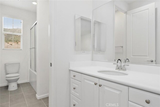 676 E Desert Willow Rd, Azusa, CA 91702 - bathroom featuring tile patterned floors, toilet, baseboards, vanity, and enclosed tub / shower combo