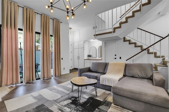 10201 Mason Ave Unit 115, Chatsworth, CA 91311 - living area with wood finished floors, stairway, a chandelier, and a high ceiling