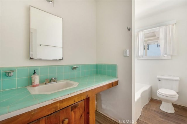 217 N Acacia Ave, Solana Beach, CA 92075 - full bath with toilet, vanity, a washtub, and wood finished floors