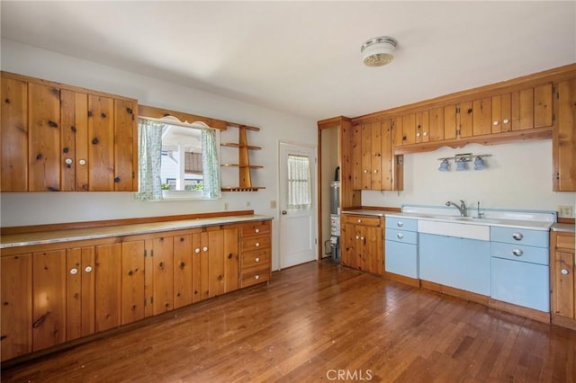 217 N Acacia Ave, Solana Beach, CA 92075 - kitchen featuring light countertops, dark wood-style flooring, a sink, and brown cabinetry