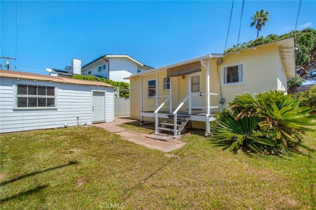 217 N Acacia Ave, Solana Beach, CA 92075 - back of house featuring an outbuilding and a lawn