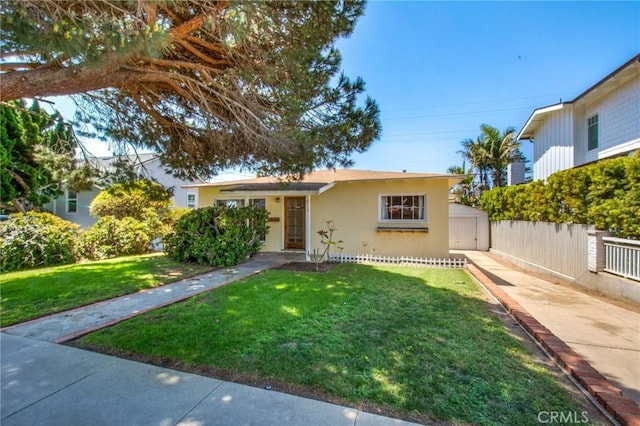 217 N Acacia Ave, Solana Beach, CA 92075 - view of front facade with concrete driveway, stucco siding, a front lawn, and fence