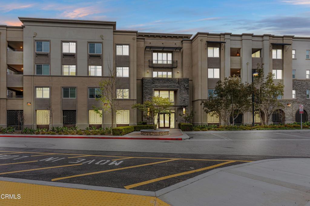 view of building exterior featuring uncovered parking