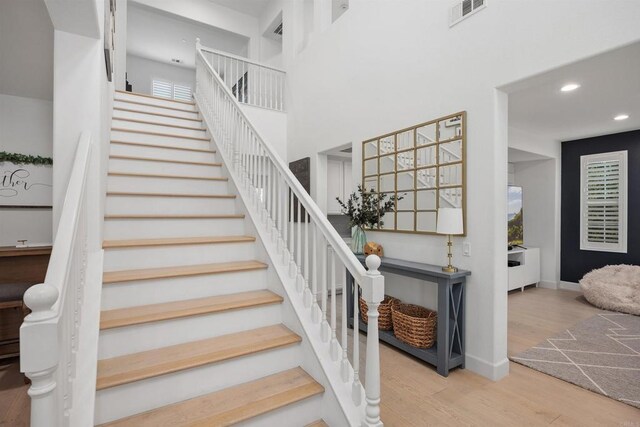 17236 Eagle Canyon Way, San Diego, CA 92127 - staircase featuring wood finished floors, recessed lighting, baseboards, and a towering ceiling