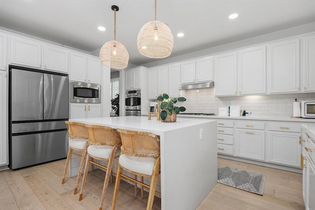17236 Eagle Canyon Way, San Diego, CA 92127 - kitchen featuring appliances with stainless steel finishes, under cabinet range hood, backsplash, white cabinetry, and recessed lighting