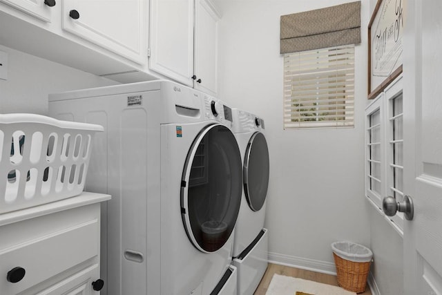17236 Eagle Canyon Way, San Diego, CA 92127 - washroom with separate washer and dryer, cabinet space, baseboards, and light wood-style floors