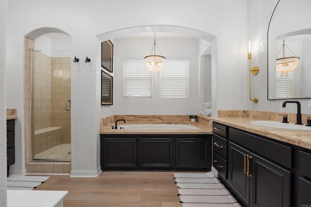 17236 Eagle Canyon Way, San Diego, CA 92127 - bathroom with vanity, a bath, wood finished floors, and a shower stall