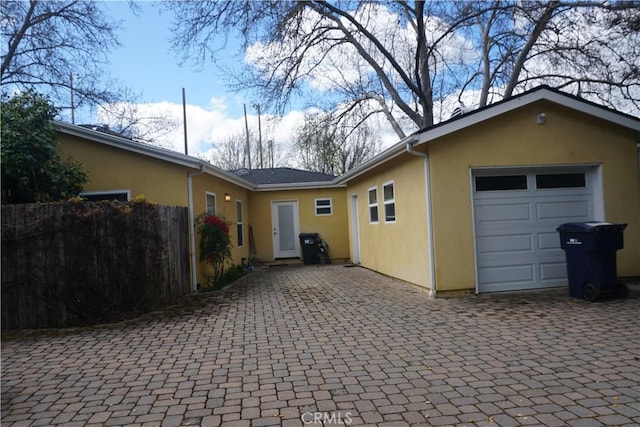 8055 Portola Rd Unit A, Atascadero, CA 93422 - view of front of house featuring stucco siding, a garage, and decorative driveway