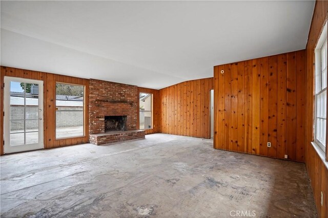 6701 Matilija Ave, Van Nuys, CA 91405 - unfurnished living room with a fireplace and wooden walls