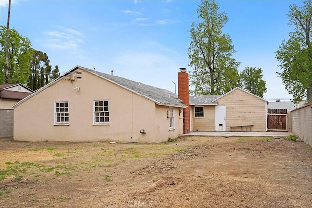 6701 Matilija Ave, Van Nuys, CA 91405 - back of property featuring a chimney, fence, a patio area, and stucco siding
