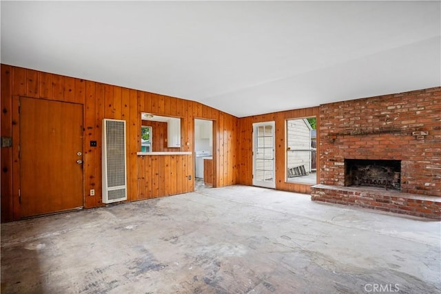 6701 Matilija Ave, Van Nuys, CA 91405 - unfurnished living room featuring healthy amount of natural light, a heating unit, vaulted ceiling, a fireplace, and wooden walls