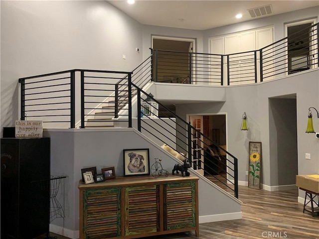 23015 Edenton Pl, Valencia, CA 91354 - staircase with baseboards, wood finished floors, visible vents, and recessed lighting