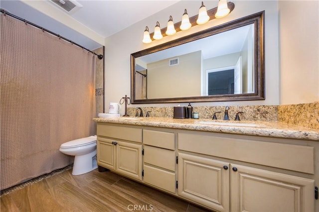23015 Edenton Pl, Valencia, CA 91354 - full bath featuring wood finished floors, a sink, double vanity, toilet, and visible vents