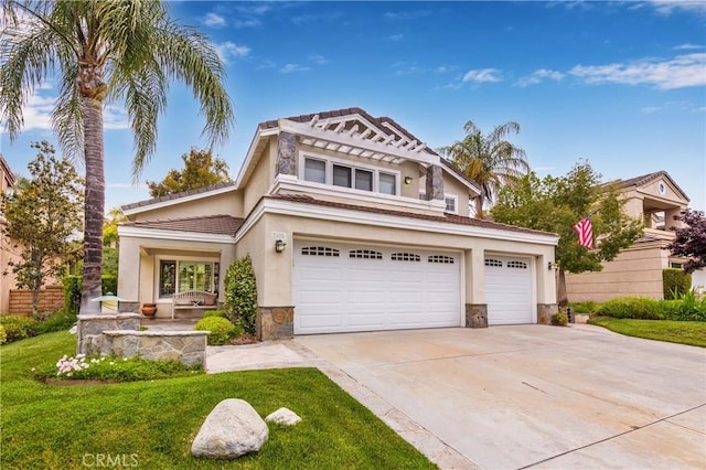 23015 Edenton Pl, Valencia, CA 91354 - view of front facade featuring concrete driveway, stone siding, a tiled roof, a front yard, and stucco siding