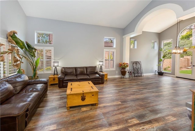 23015 Edenton Pl, Valencia, CA 91354 - living area with dark wood finished floors, an inviting chandelier, arched walkways, baseboards, and high vaulted ceiling