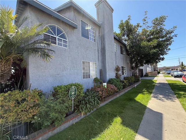 3702 W 126th St, Hawthorne, CA 90250 - view of side of home featuring stucco siding and a chimney