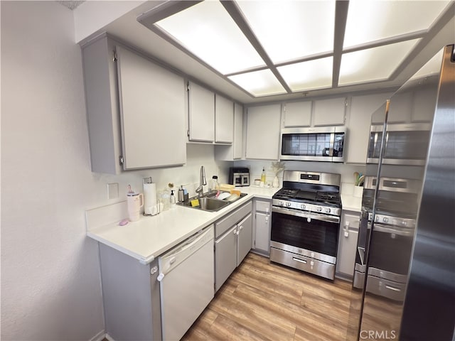 3702 W 126th St, Hawthorne, CA 90250 - kitchen featuring light wood-style flooring, stainless steel appliances, a sink, light countertops, and gray cabinets