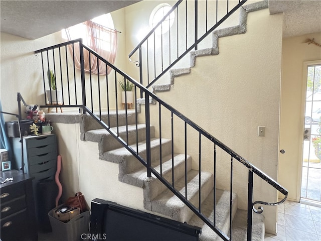 3702 W 126th St, Hawthorne, CA 90250 - staircase featuring a textured ceiling, marble finish floor, and a textured wall