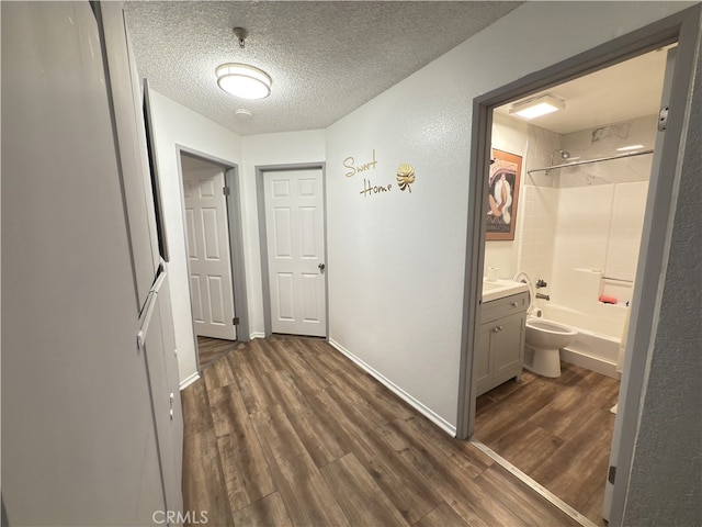 3702 W 126th St, Hawthorne, CA 90250 - hall with baseboards, dark wood-style flooring, and a textured ceiling