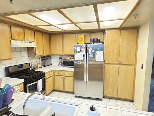 3702 W 126th St, Hawthorne, CA 90250 - kitchen featuring a sink, tile countertops, under cabinet range hood, appliances with stainless steel finishes, and decorative backsplash