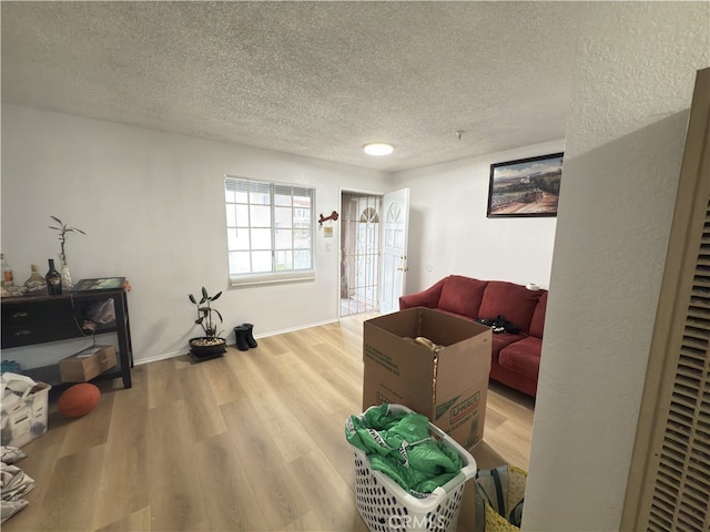 3702 W 126th St, Hawthorne, CA 90250 - living area with a textured ceiling, baseboards, and wood finished floors