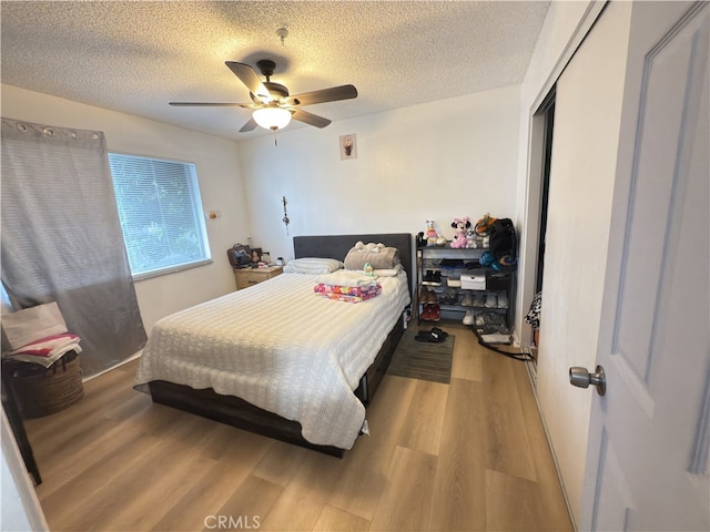 3702 W 126th St, Hawthorne, CA 90250 - bedroom featuring a textured ceiling, a closet, a ceiling fan, and light wood-style floors