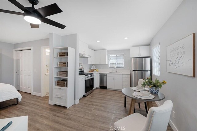 653 Joann St, Costa Mesa, CA 92627 - kitchen featuring appliances with stainless steel finishes, a sink, light countertops, white cabinetry, and baseboards