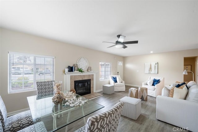653 Joann St, Costa Mesa, CA 92627 - living room featuring a tiled fireplace, baseboards, a ceiling fan, and wood finished floors