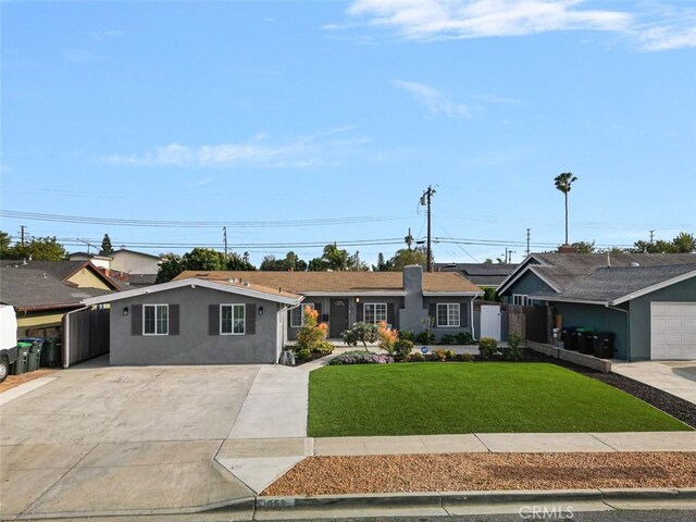 653 Joann St, Costa Mesa, CA 92627 - ranch-style home with a front lawn, stucco siding, driveway, and fence