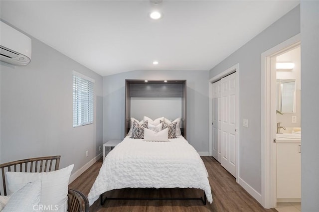 653 Joann St, Costa Mesa, CA 92627 - bedroom with wood finished floors, baseboards, recessed lighting, a wall mounted AC, and a sink
