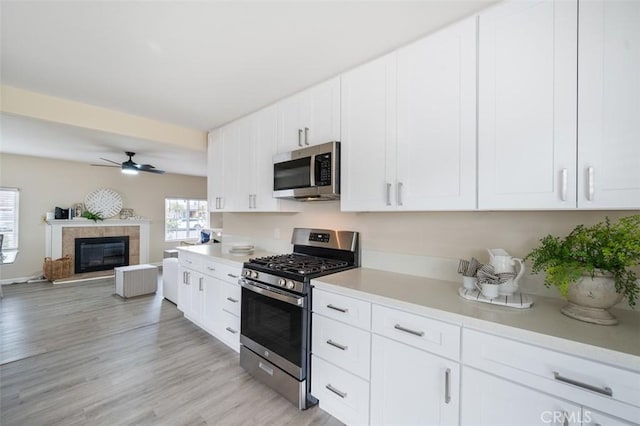 653 Joann St, Costa Mesa, CA 92627 - kitchen featuring open floor plan, light countertops, white cabinetry, a ceiling fan, and stainless steel appliances