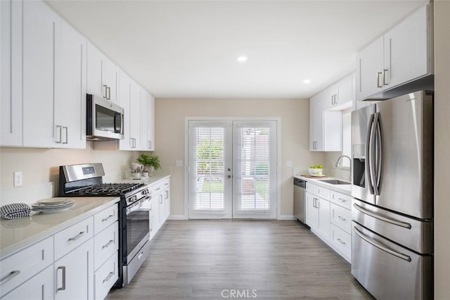 653 Joann St, Costa Mesa, CA 92627 - kitchen with light countertops, baseboards, appliances with stainless steel finishes, and a sink