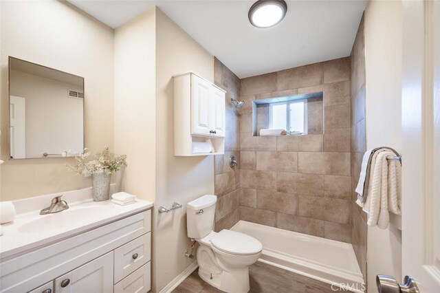 653 Joann St, Costa Mesa, CA 92627 - full bath featuring vanity, wood finished floors, a tile shower, and toilet