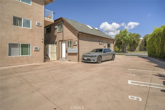 1344 E Broadway, Glendale, CA 91205 - view of side of property with uncovered parking, stairway, and a balcony