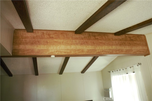 room details featuring beam ceiling and a wall mounted air conditioner